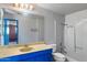 Bathroom featuring a blue vanity, vintage fixtures, and a combined tub and shower at 2230 N 12Th St # Rear, Phoenix, AZ 85006