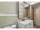 Bathroom featuring a sink with vanity, mirror and tiled shower and toilet at 2230 N 12Th St # Rear, Phoenix, AZ 85006
