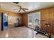 Bonus room featuring wood paneling, tile floors, double doors, and access to a bathroom at 2230 N 12Th St # Rear, Phoenix, AZ 85006