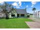 Charming home with lush green lawn, mature tree, and a classic design enhances curb appeal at 2230 N 12Th St # Rear, Phoenix, AZ 85006