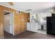 Small living room featuring wood paneling, a small breakfast bar, vintage cabinets and appliances at 2230 N 12Th St # Rear, Phoenix, AZ 85006