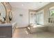Modern bathroom features a soaking tub, glass shower, double vanity, and bright lighting at 22756 N 91St Way, Scottsdale, AZ 85255
