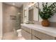 Modern bathroom with a glass-enclosed shower, quartz counters, and light wood cabinets at 22756 N 91St Way, Scottsdale, AZ 85255