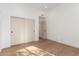 Bedroom with wood floors, a closet, an entry door, and neutral-colored walls at 22756 N 91St Way, Scottsdale, AZ 85255