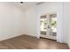 A bright bedroom featuring wood floors and glass doors leading to an outdoor patio at 22756 N 91St Way, Scottsdale, AZ 85255