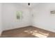 A cozy bedroom with wood floors and multiple windows that let in natural light at 22756 N 91St Way, Scottsdale, AZ 85255