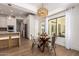 Bright dining room showcases a glass-top table with metal chairs and modern lighting fixture at 22756 N 91St Way, Scottsdale, AZ 85255