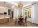 Bright dining room showcases a glass-top table with metal chairs and modern lighting fixture at 22756 N 91St Way, Scottsdale, AZ 85255