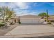 Exterior showcasing a well-maintained home with a spacious driveway and three-car garage at 22756 N 91St Way, Scottsdale, AZ 85255