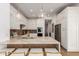 Contemporary kitchen featuring a stone breakfast bar, stainless steel appliances, and ample white cabinetry at 22756 N 91St Way, Scottsdale, AZ 85255
