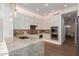 Modern kitchen features a stone breakfast bar, stainless steel appliances, and ample white cabinets at 22756 N 91St Way, Scottsdale, AZ 85255