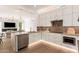 Modern kitchen features white cabinetry, stainless steel appliances, and marble countertops at 22756 N 91St Way, Scottsdale, AZ 85255