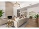 Comfortable living room features hardwood floors, soaring ceilings, elegant chandelier, and an inviting fireplace at 22756 N 91St Way, Scottsdale, AZ 85255