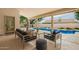 A covered patio with comfortable seating next to a pool for outdoor relaxation and entertainment at 22756 N 91St Way, Scottsdale, AZ 85255