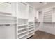 Bright walk-in closet featuring white shelving and hanging rods for optimal organization and storage at 22756 N 91St Way, Scottsdale, AZ 85255