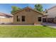 A well-maintained backyard features a lush lawn and simple landscaping creating a peaceful outdoor setting at 2424 E Peach Tree Dr, Chandler, AZ 85249