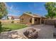 View of backyard featuring a patio with brick pavers and lush lawn; perfect for outdoor enjoyment at 2424 E Peach Tree Dr, Chandler, AZ 85249