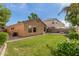 A spacious backyard features a well-maintained lawn and desert landscaping providing a private outdoor space at 2424 E Peach Tree Dr, Chandler, AZ 85249