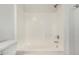 Bathroom features a white shower-tub combination with white tiling and brushed-silver hardware at 2424 E Peach Tree Dr, Chandler, AZ 85249