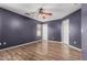 Bedroom with wood-look floors, gray walls, ceiling fan, a window and white doors at 2424 E Peach Tree Dr, Chandler, AZ 85249