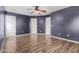 The bedroom features wood-look floors, gray walls and three white doors at 2424 E Peach Tree Dr, Chandler, AZ 85249