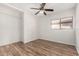 Bedroom featuring wood floors, a window and a ceiling fan at 2424 E Peach Tree Dr, Chandler, AZ 85249