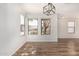 Inviting dining area with views through windows, complemented by a modern light fixture at 2424 E Peach Tree Dr, Chandler, AZ 85249