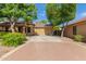 Charming single-story home featuring desert landscaping, mature trees, and a two-car garage at 2424 E Peach Tree Dr, Chandler, AZ 85249