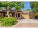 Inviting single-story home with a well-maintained front yard and a convenient two-car garage at 2424 E Peach Tree Dr, Chandler, AZ 85249