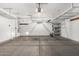 Garage featuring a garage door and shelving units at 2424 E Peach Tree Dr, Chandler, AZ 85249
