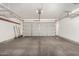 Garage featuring a garage door and shelving units at 2424 E Peach Tree Dr, Chandler, AZ 85249