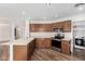 Updated kitchen featuring stainless steel appliances, wood cabinetry, light countertops, and wood-look flooring at 2424 E Peach Tree Dr, Chandler, AZ 85249
