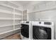 Laundry room featuring tile floors, modern machines and built in shelving at 2424 E Peach Tree Dr, Chandler, AZ 85249