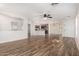 Spacious living area with wood-look floors, flowing seamlessly into the kitchen at 2424 E Peach Tree Dr, Chandler, AZ 85249