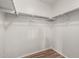 This walk-in closet features built in shelving and laminate floors at 2424 E Peach Tree Dr, Chandler, AZ 85249