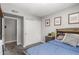 Cozy bedroom features a large closet, baseball-themed art, and a comfortable bed with patterned pillows at 2444 S Noche De Paz --, Mesa, AZ 85202
