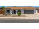 Charming single-story home with a well-maintained yard and attached two-car garage at 2444 S Noche De Paz --, Mesa, AZ 85202