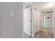 Neutral hallway with tile floors and ample storage with many closet doors at 2444 S Noche De Paz --, Mesa, AZ 85202