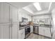 Modern kitchen with stainless-steel appliances, white cabinetry, and abundant natural light at 2444 S Noche De Paz --, Mesa, AZ 85202