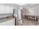Open concept kitchen with stainless steel refrigerator and view into the dining area at 2444 S Noche De Paz --, Mesa, AZ 85202