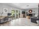Sunlit living room with a fireplace, sliding glass doors, and a dedicated office space at 2444 S Noche De Paz --, Mesa, AZ 85202