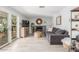 Cozy living room with a modern fireplace, neutral tones, and access to the outdoor patio at 2444 S Noche De Paz --, Mesa, AZ 85202