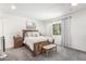 Comfortable main bedroom with carpet, ceiling fan and natural light from the large window at 2444 S Noche De Paz --, Mesa, AZ 85202