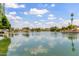 Expansive lake reflecting the blue sky and clouds, surrounded by community homes and landscaping at 2616 S El Dorado --, Mesa, AZ 85202
