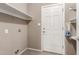 Neutral laundry room with shelving, a tiled floor, and a white door at 2616 S El Dorado --, Mesa, AZ 85202
