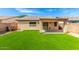 Beautiful backyard with artificial turf and covered patio, providing a low-maintenance and stylish outdoor space at 30212 N Sunray Dr, San Tan Valley, AZ 85143