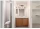 Bathroom vanity features wood cabinet, white countertop and framed mirror at 30212 N Sunray Dr, San Tan Valley, AZ 85143