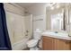Bathroom features tub and shower combination plus vanity with decorative mirror at 30212 N Sunray Dr, San Tan Valley, AZ 85143
