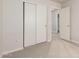Bedroom featuring neutral carpet, closet with sliding doors and a doorway to ensuite at 30212 N Sunray Dr, San Tan Valley, AZ 85143