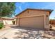 Single-story home featuring a two-car garage and low-maintenance desert landscaping at 30212 N Sunray Dr, San Tan Valley, AZ 85143